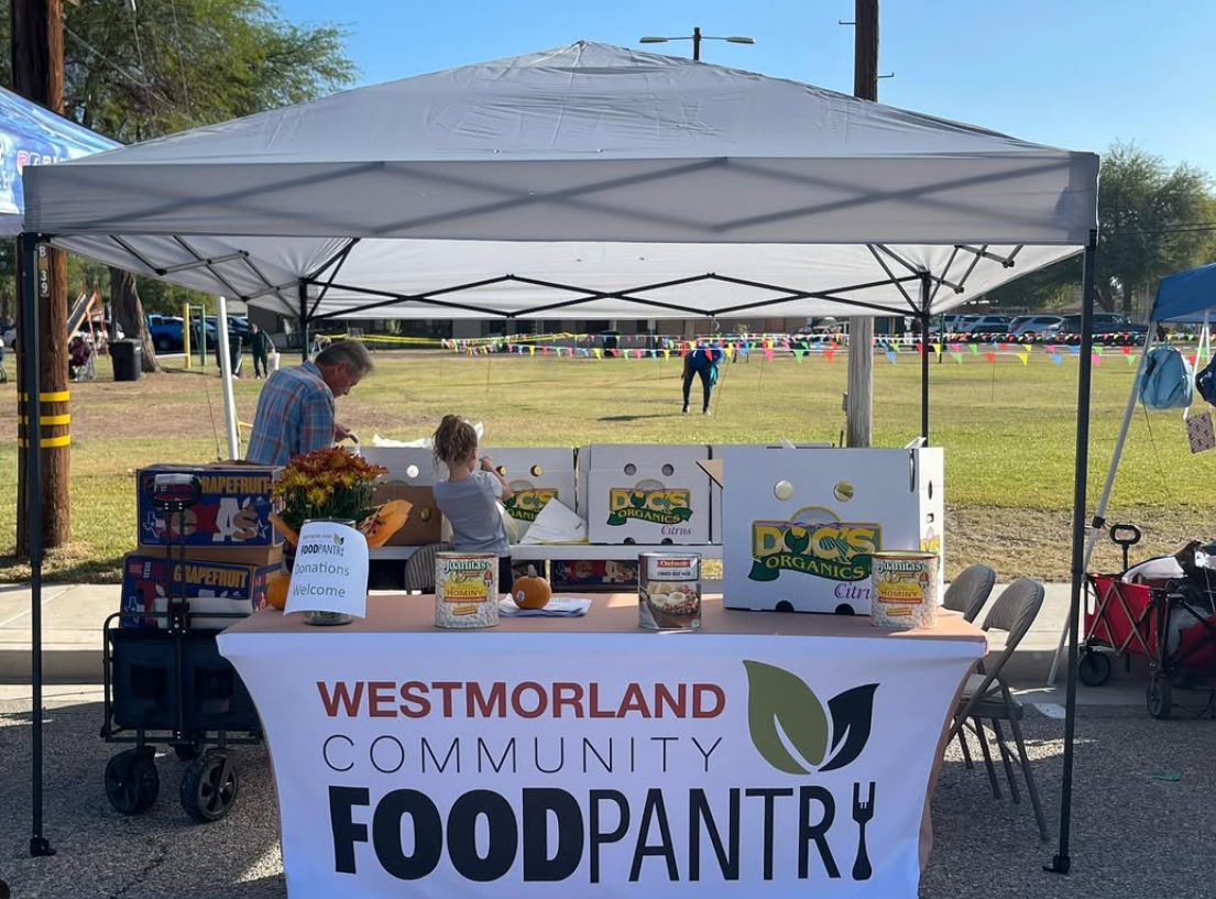 Westmorland Community Food Pantry tabling at a farmer's market.