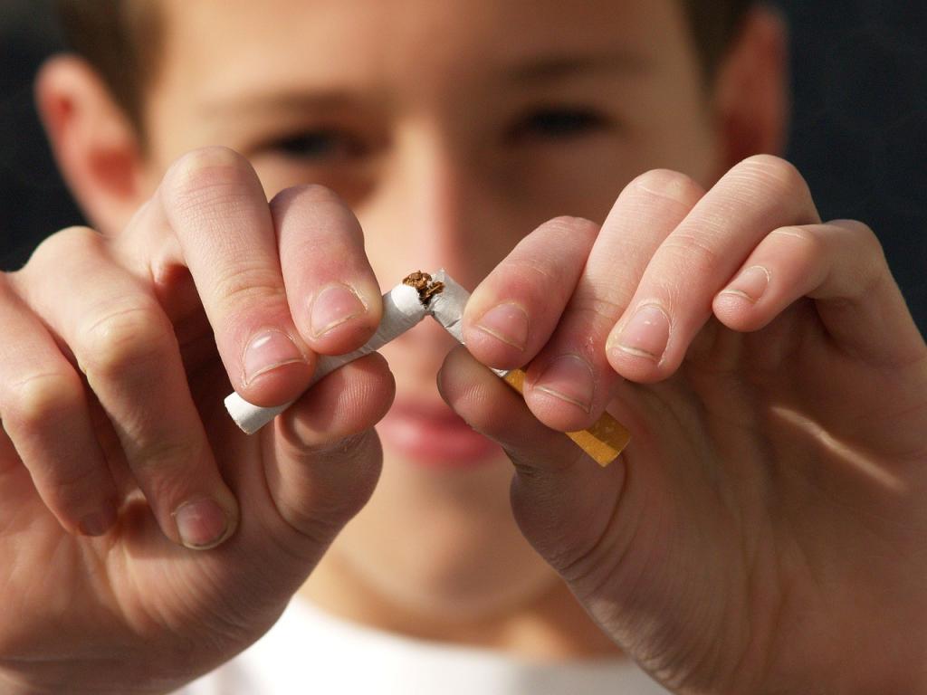 Child breaks a cigarette in half.