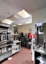 inside the kitchen/prep area of a retail restaurant with stainless steel equipment