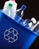 close up photo of small recycling trash can with an assortment of plastic bottles 