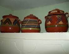 pots sitting on top of a cabinet inside a house