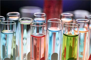 close up of laboratory test tubes filled with different colored samples